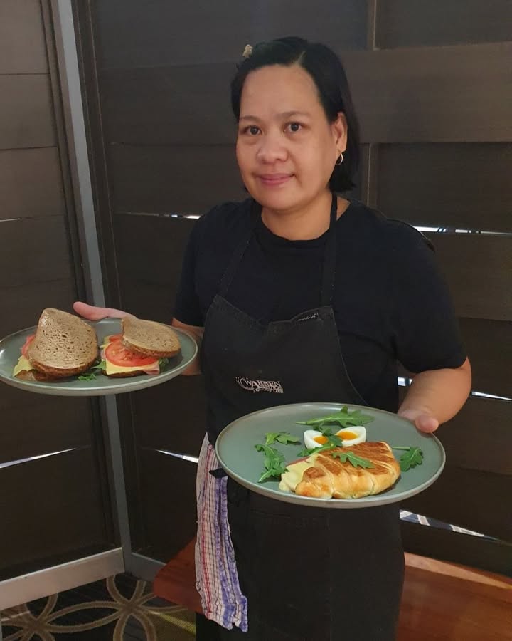 Featured image for “A very proud Head Chef Roslyn showing off a couple of delicious Sunday Brunch options – a flaky croissant and a toasted sandwich on sourdough!”